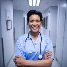 portrait of a female nurse standing in a corridor